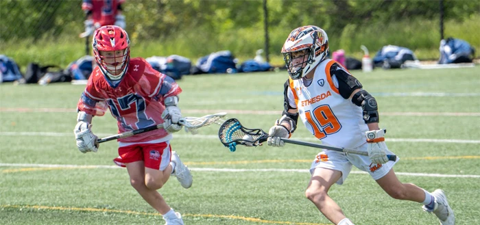 Lacrosse players competing on the field